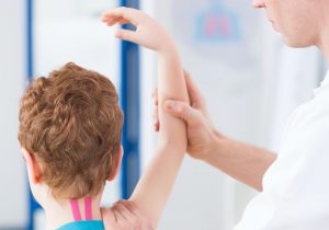 Boy during kinesio taping therapy