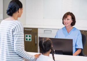 Nurse talking with a patient at counter